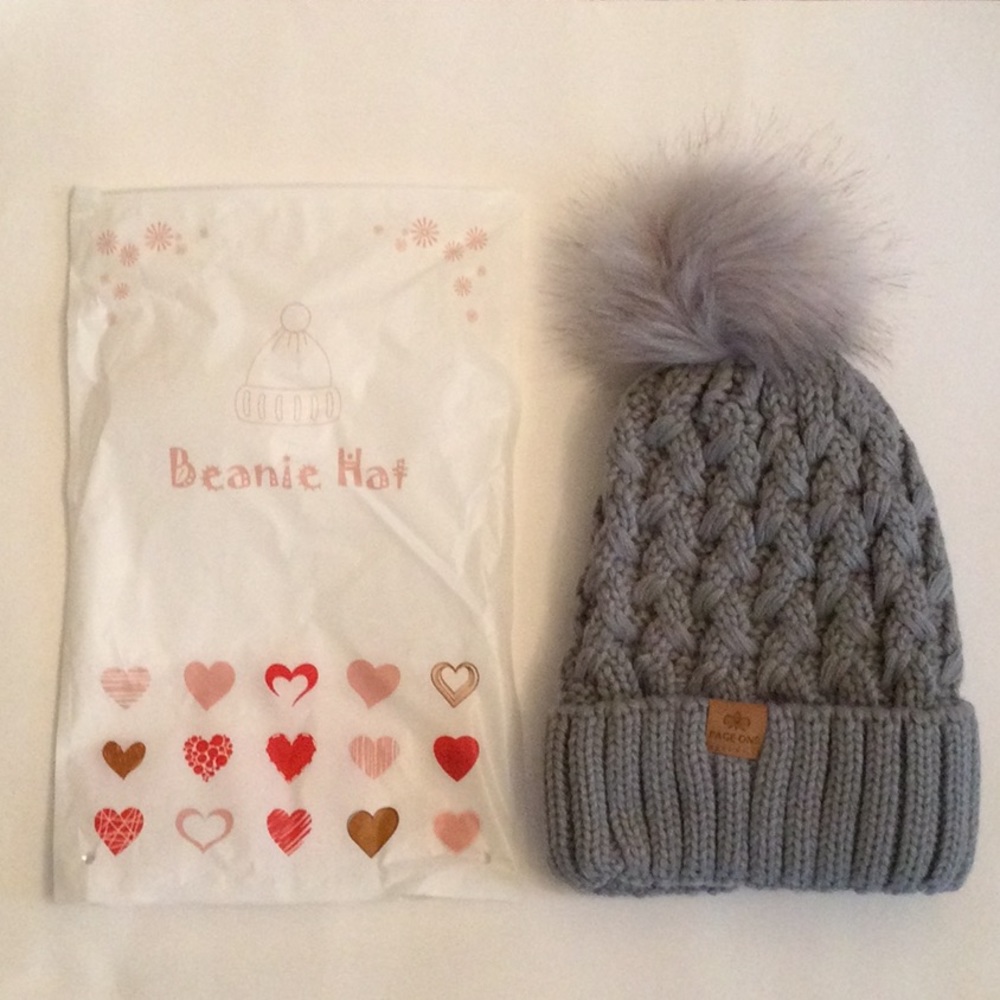 New Page One Beanie Hat, Grey Color, with furry ball on top.